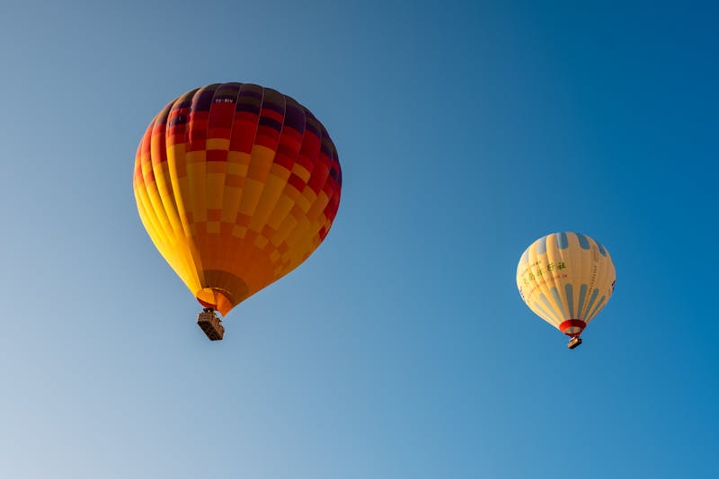 Luxury hot air balloon floating over ancient Luxor temples